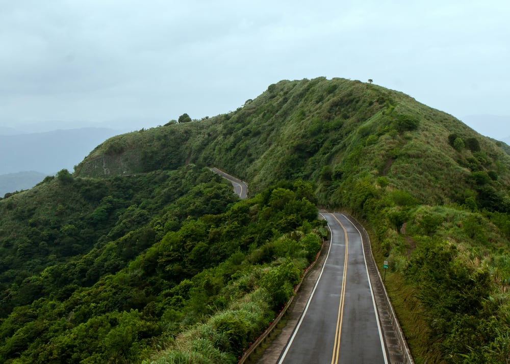 Road through green mountains in Taiwan