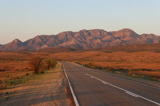 Road through red coloured landscape in Australia