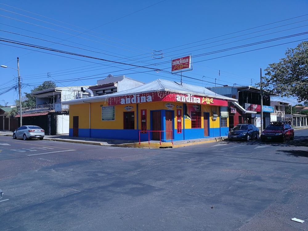 Intersection with cars and colorfoul building in Costa Rica
