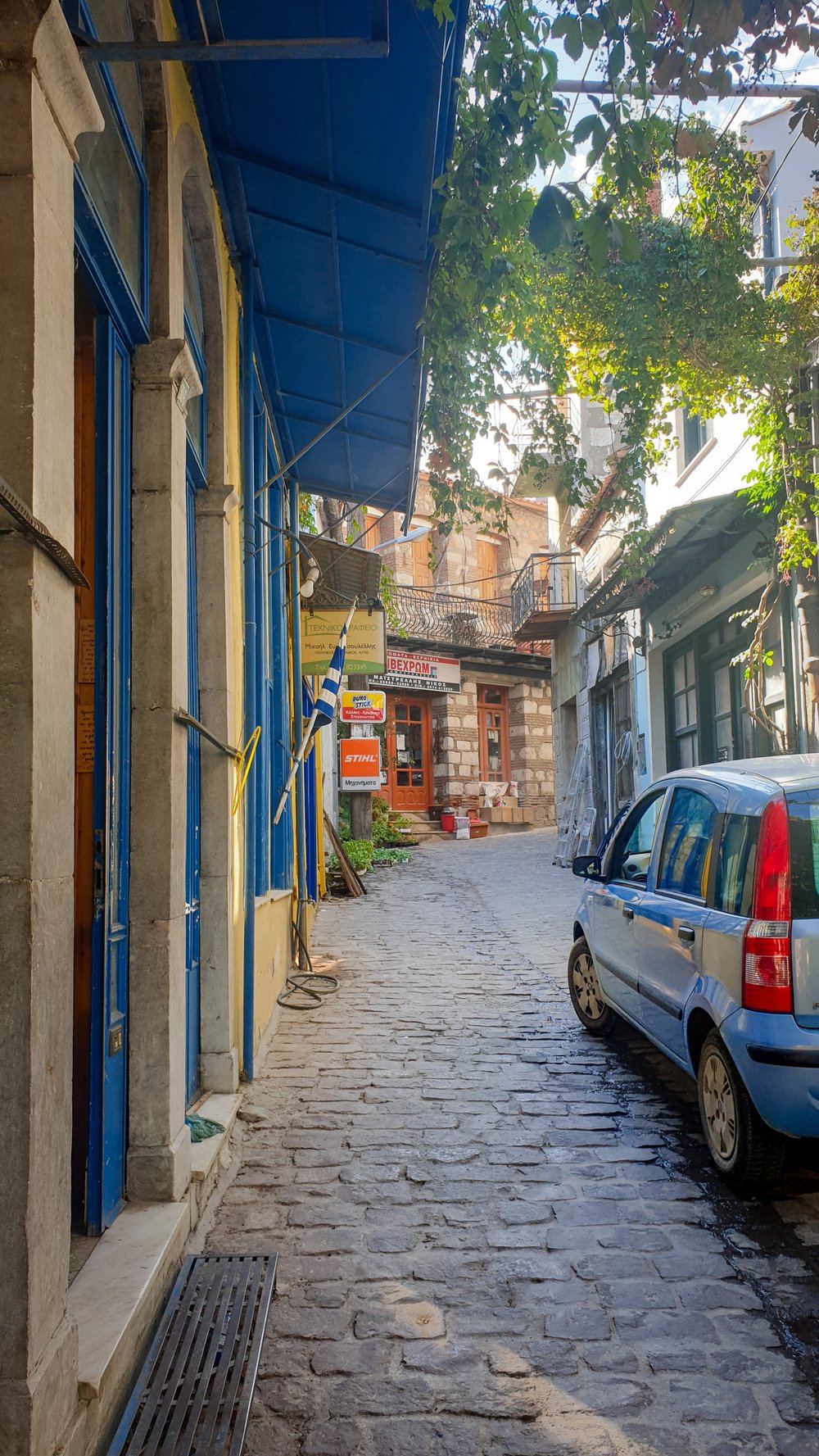 A parked car in a narrow street in the village of Lesbos.