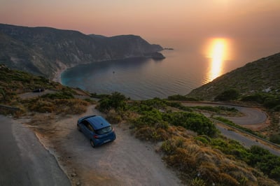 A parked car at a bay during a sunset in Greece.