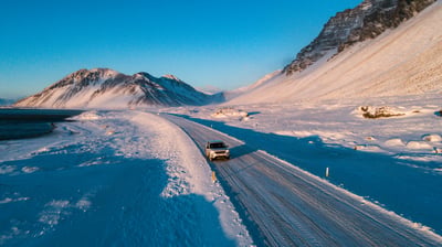 Snowy landscape with 4x4 on the road in Iceland