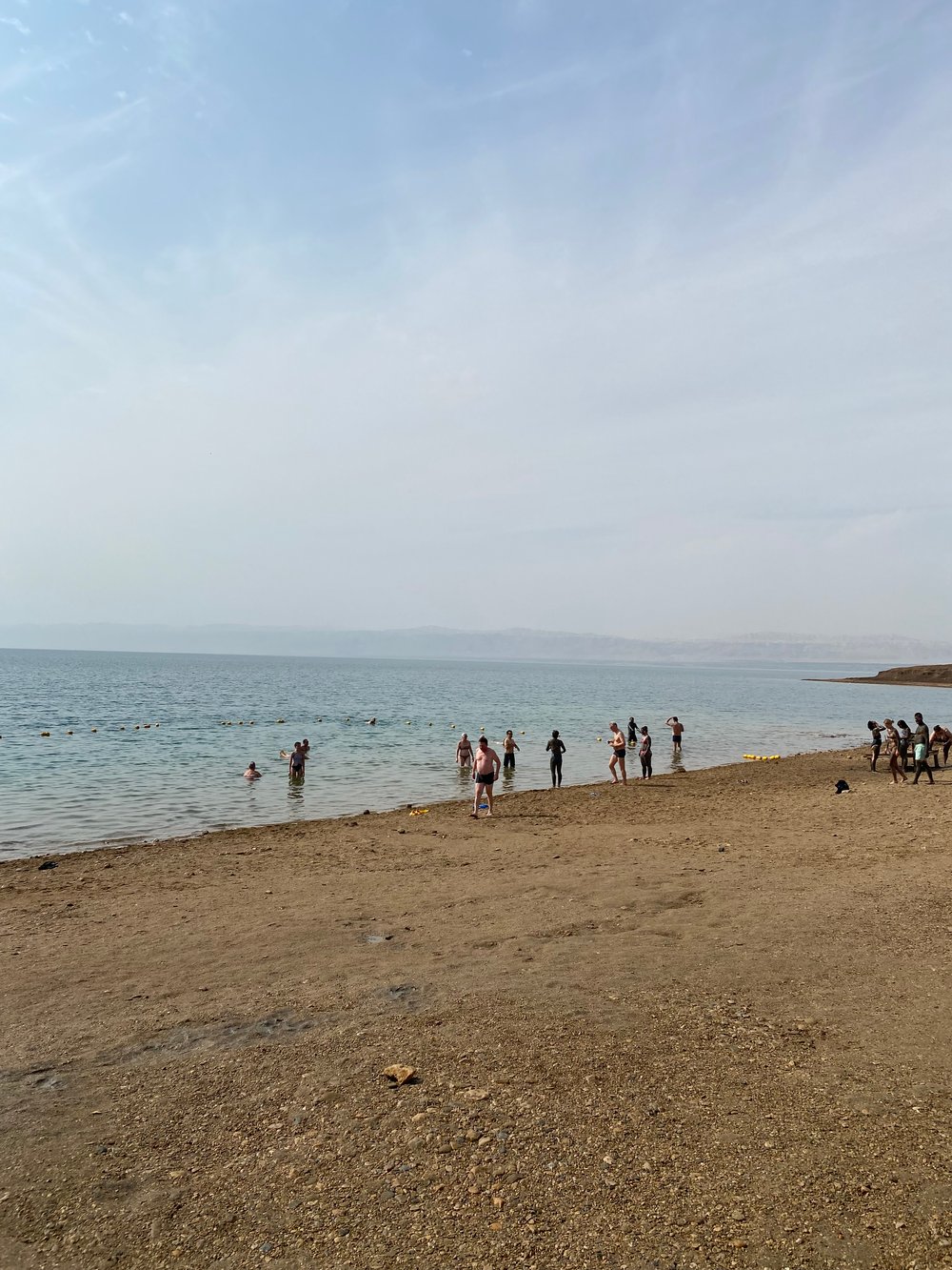Taking a mud bath at the beach of the Dead Sea