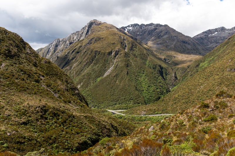 View of the otira valley track with green mountains surrounding.