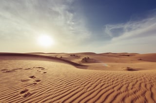 An empty desert with a sun