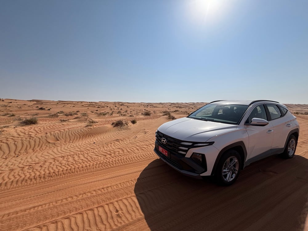 White car in desert Oman