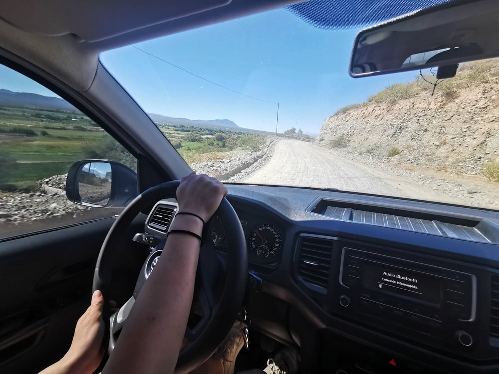 View  at the road and wheel from front passenger seat, Argentina