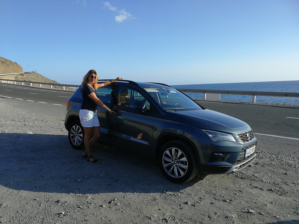 Woman next to SUV on Spanish road