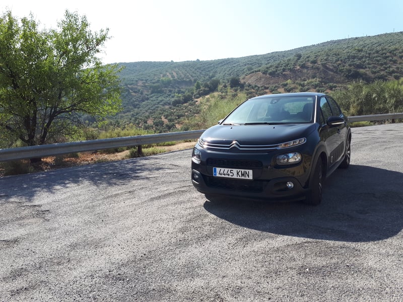 Dark car at the side of the road in Spain