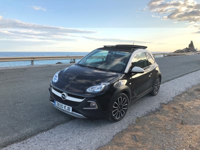 Dark rental car parked at sea in Spain
